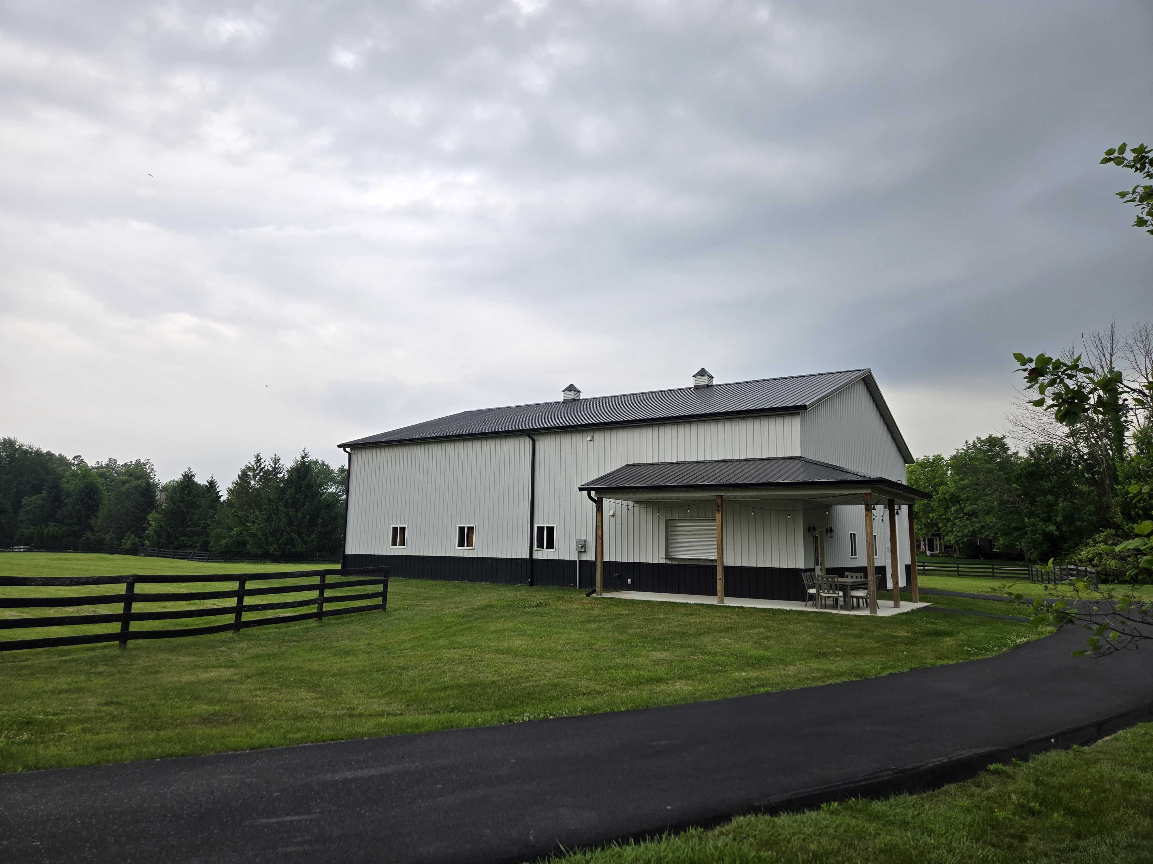 Black and White Post Frame Garage Sports Barn Building